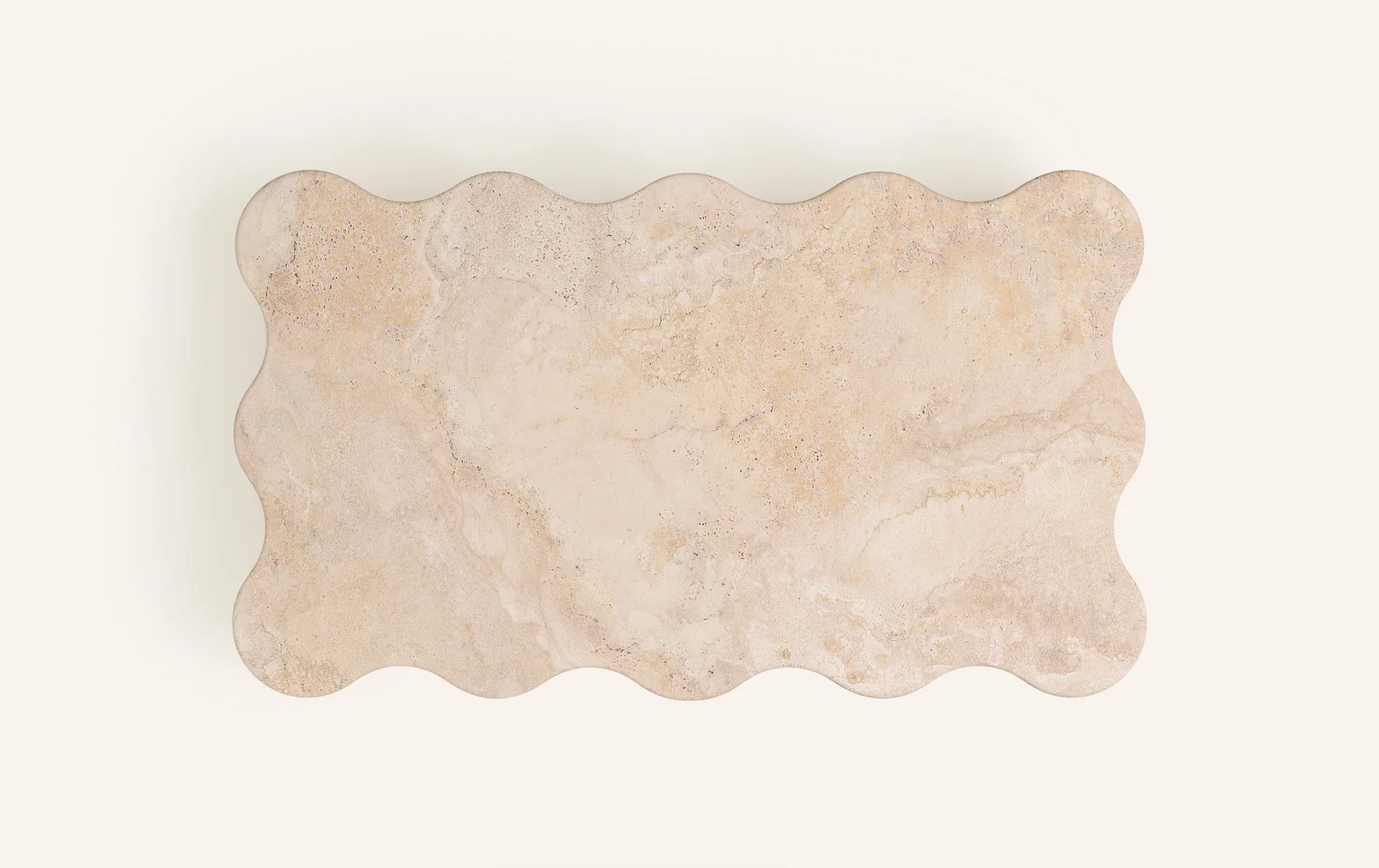 Balla travertine coffee table top view showing wave-form edge and sphere geometry