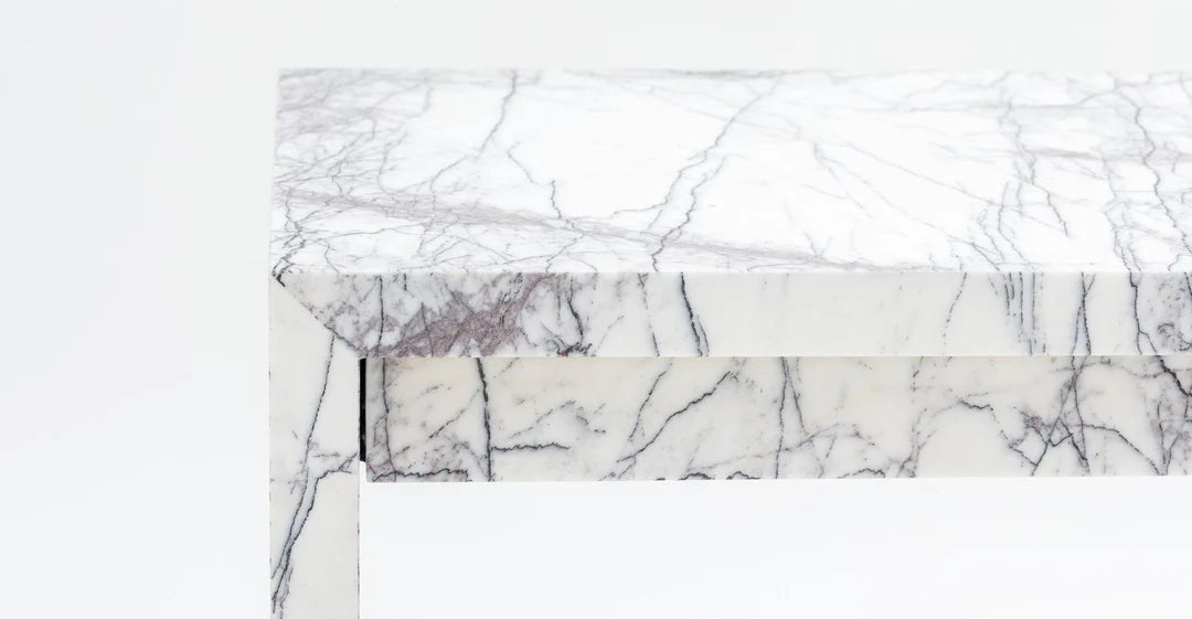 Close up of New York marble surface showing lilac and grey veining on white background