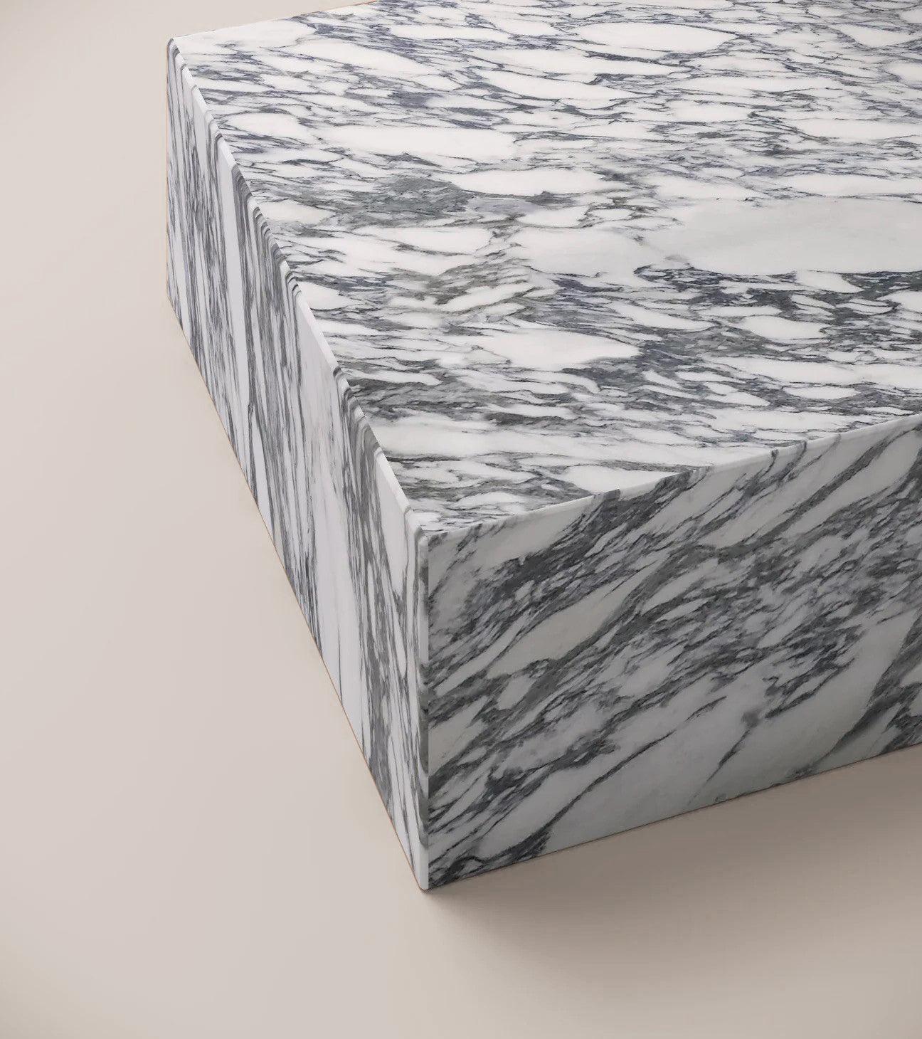 Close up of Statuario rectangular plinth surface showing refined white marble and grey veins