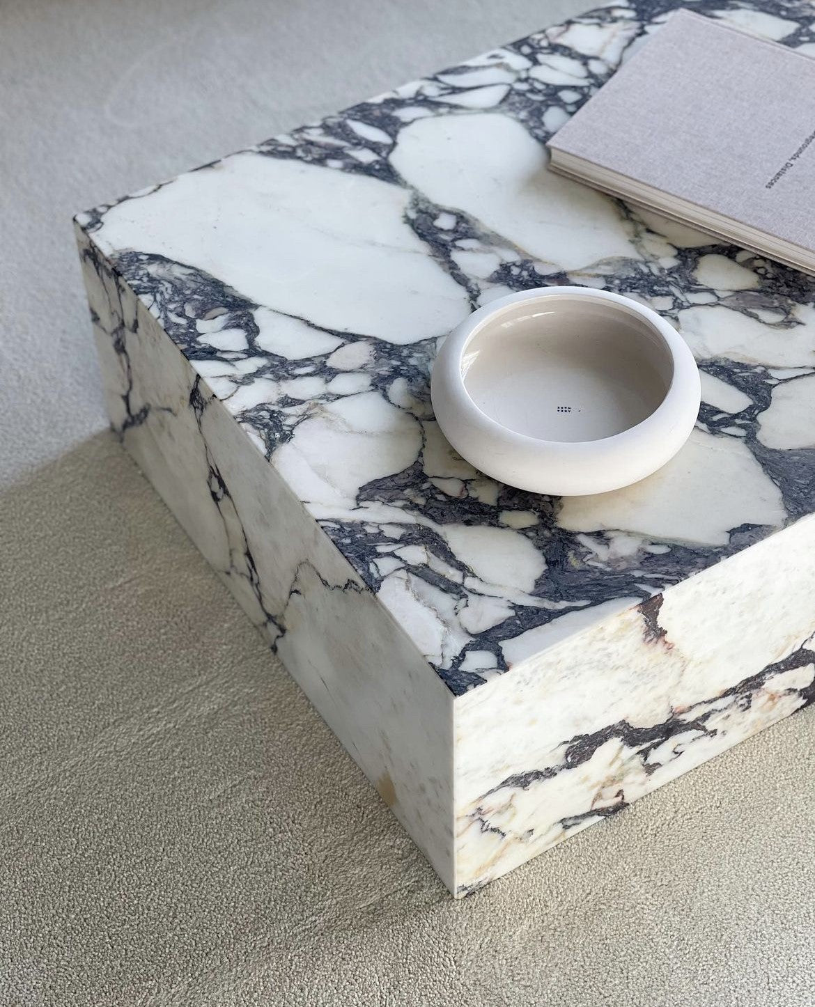 Slab rectangular marble plinth coffee table styled in living room — 1500mm low profile centrepiece