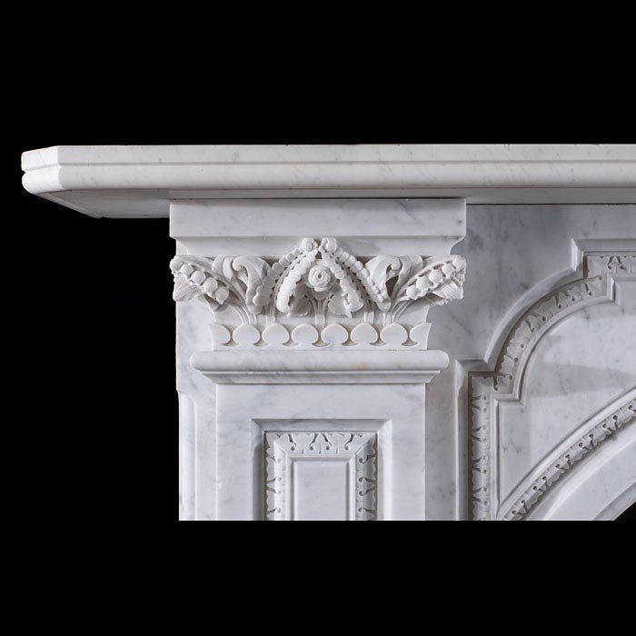 Left Corinthian capital detail on Grand Victorian Carrara marble fireplace — hand-carved acanthus leaves and floral rosettes