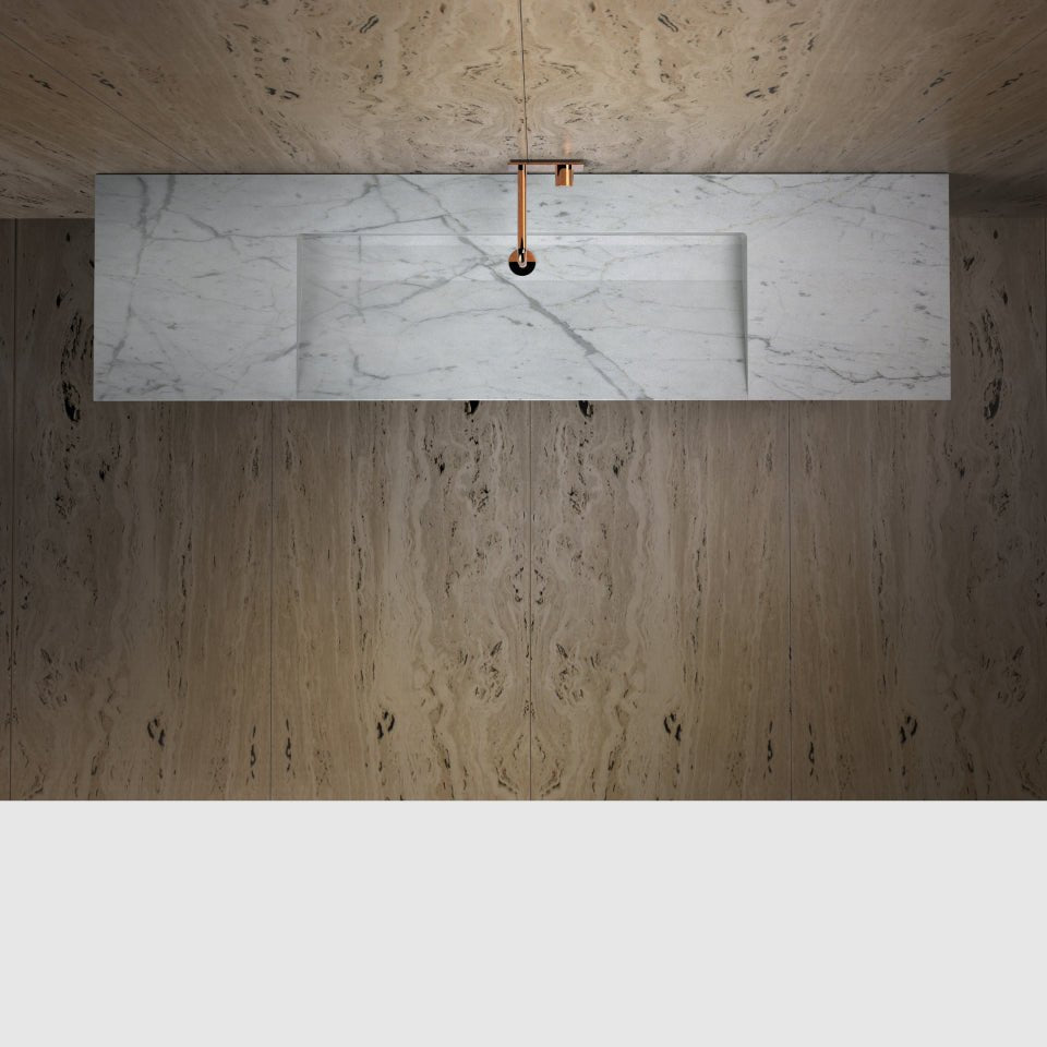 Carrara marble integrated basin — overhead view showing carved basin interior and stone pop-up waste