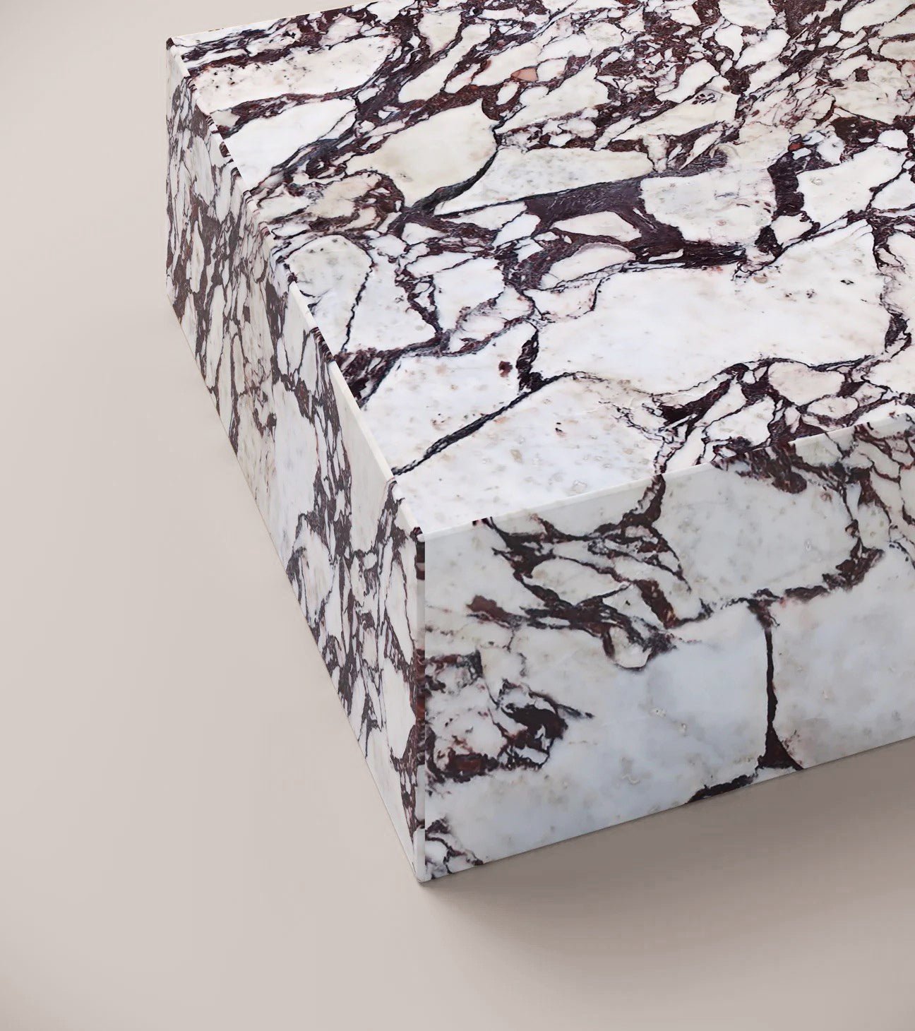 Close up of Calacatta Viola plinth coffee table surface showing purple and grey veining