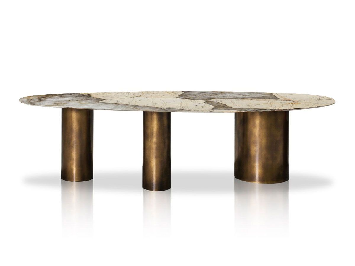 Sienna Patagonia quartzite oval dining table on three brushed brass cylinder legs — 2900mm seats 12
